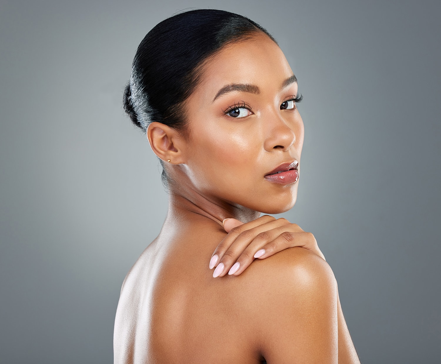 Woman looking over her shoulder with elegant pose.